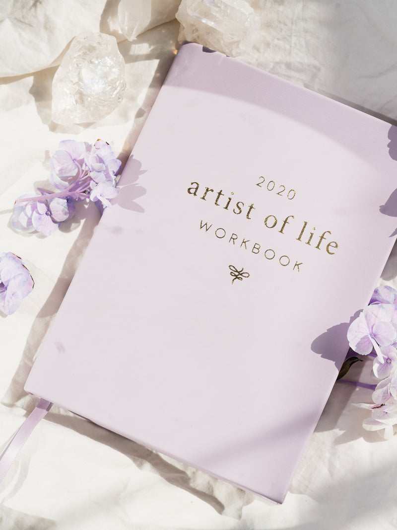 lavender artist of life workbook surrounded by white crystals and purple flowers